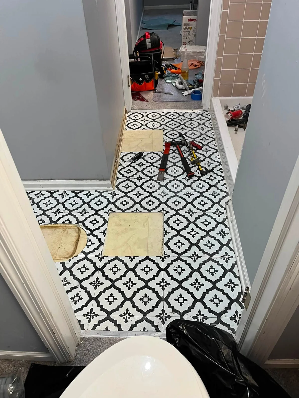 Patterned bathroom floor tile during installation